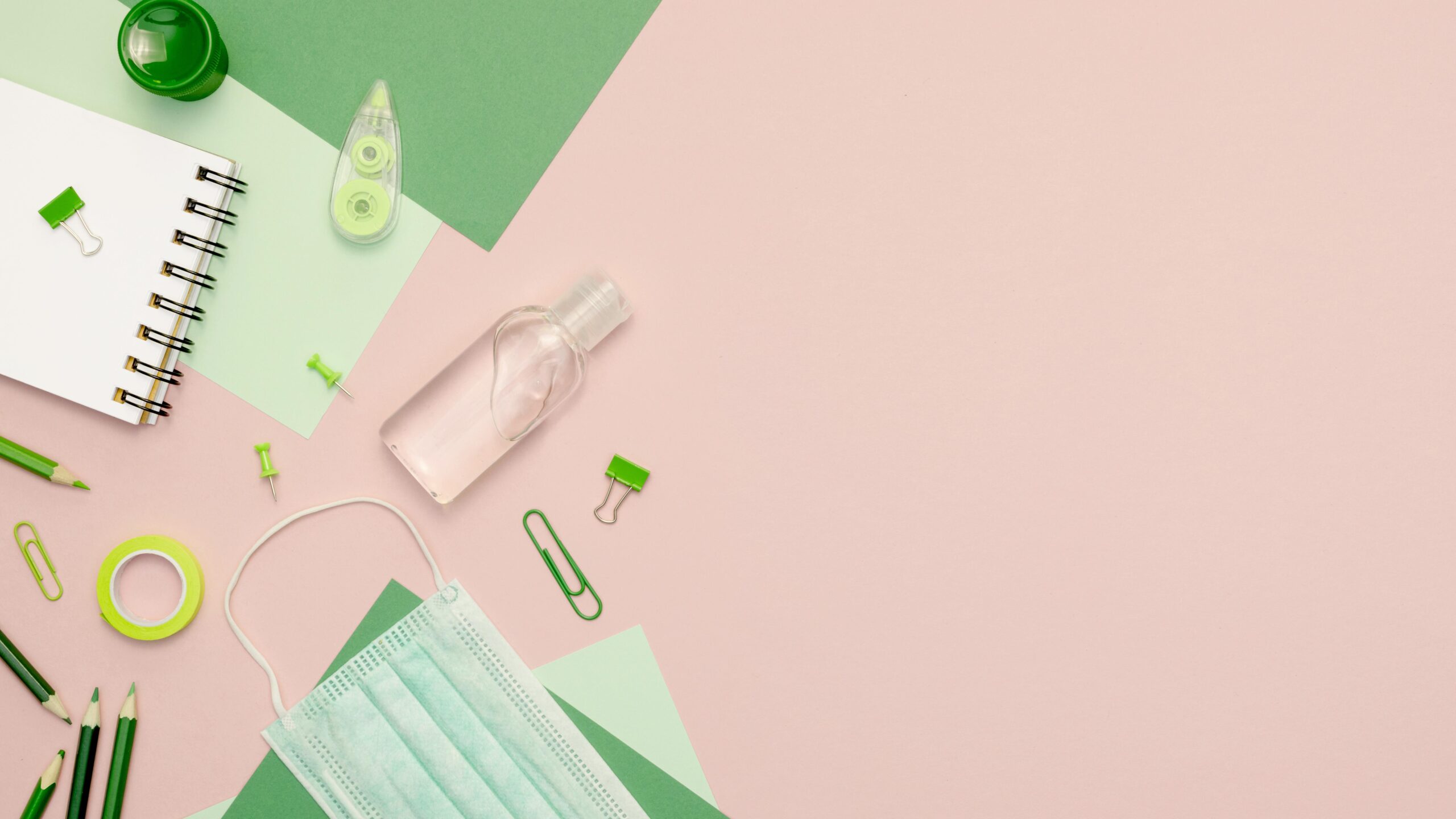 top-view-green-supplies-pink-background